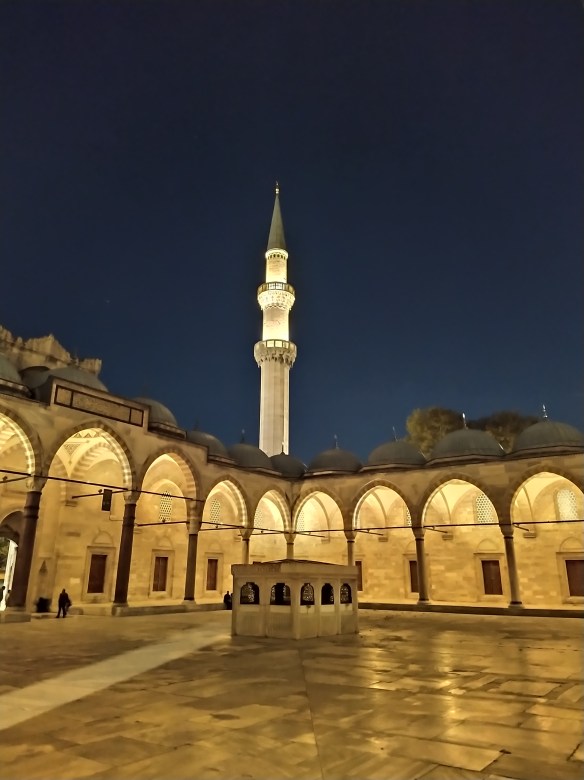 Mosque at night illuminated in yellow light
