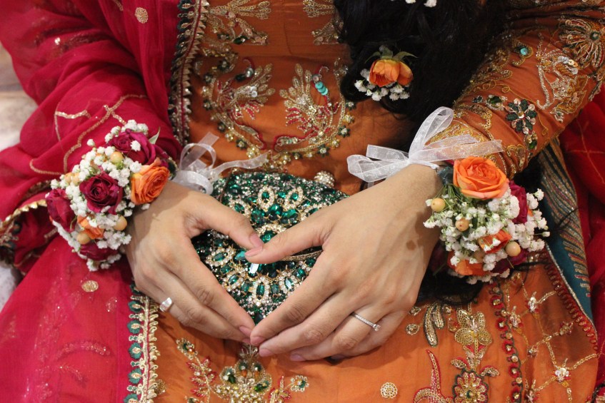 Bride in colourful outfit and green ourse