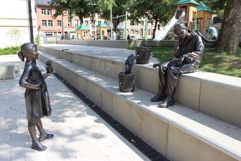 Children statues, one sitting one standing