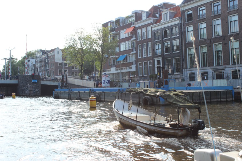 Man with his pet egret on a boat