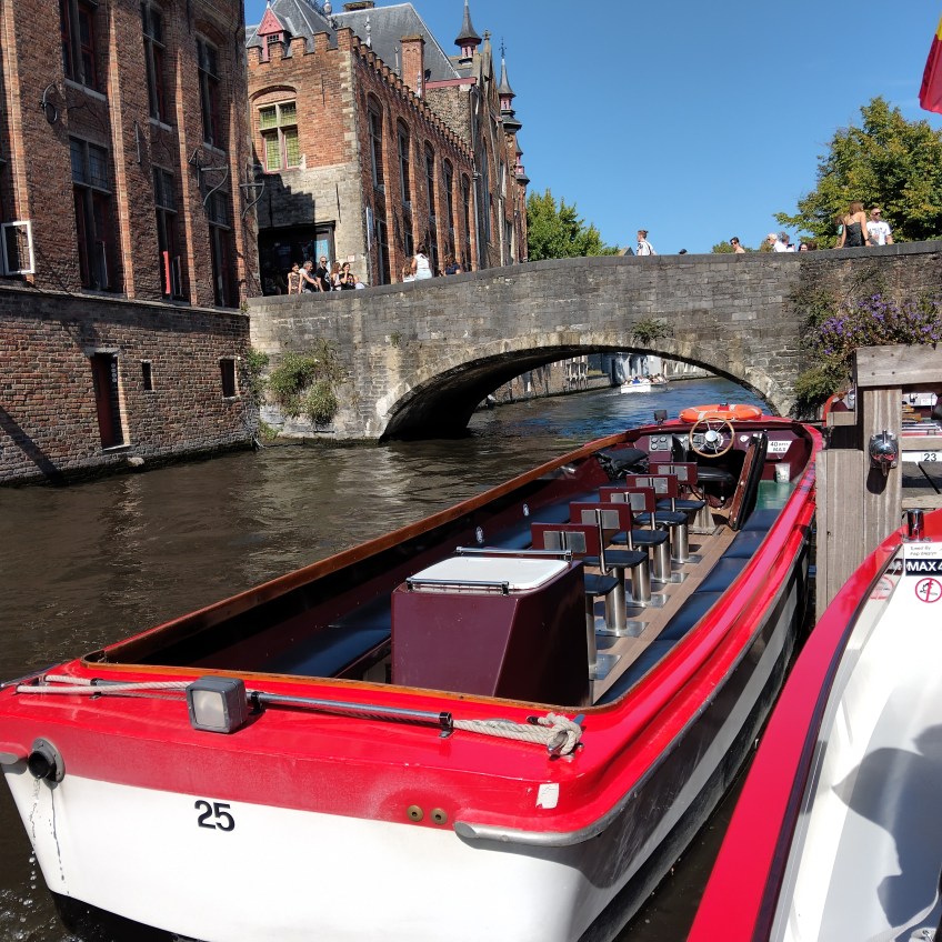 Red and white boat on a canal