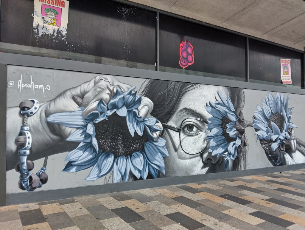 A person holding sunflowers