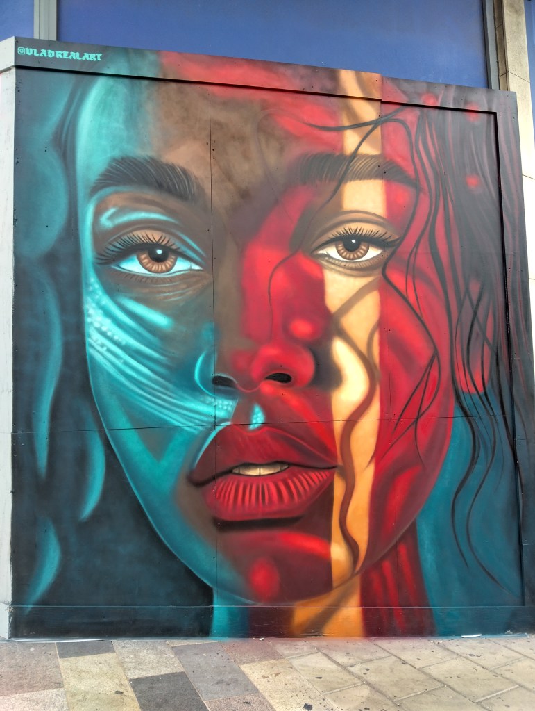 A young woman in red and blues